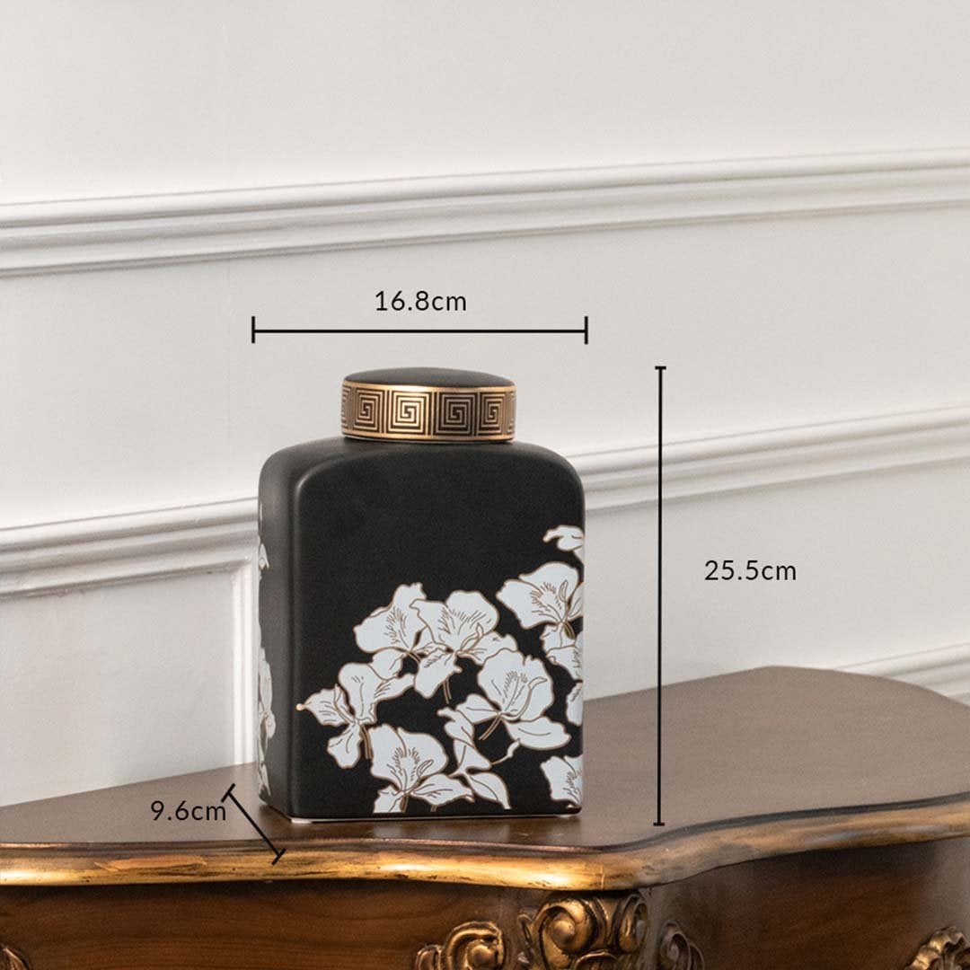 Black square jar with white floral artwork in a front view measuring 15.5 cm width and 20.8 cm height perfect for luxury décor styling.