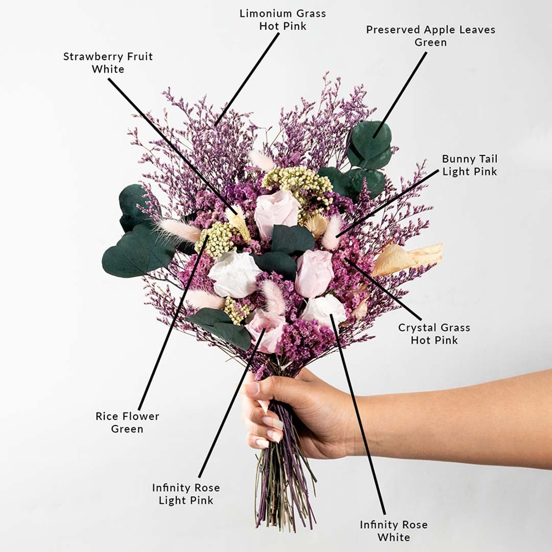 Decorative dried flower bouquet with infinity rose crystal grass limonium grass bunny tail strawberry fruit and apple leaves.