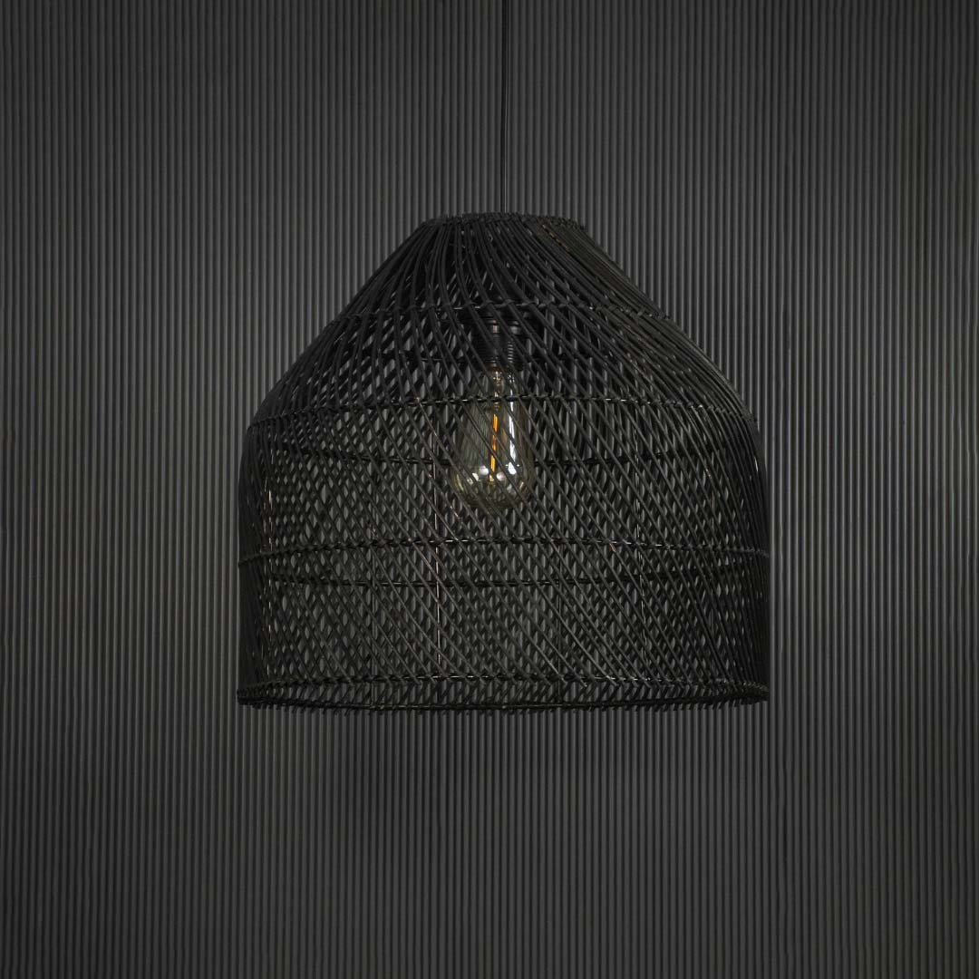 Stylish black rattan pendant lamp against black background highlighting natural weave and sophisticated curved silhouette.