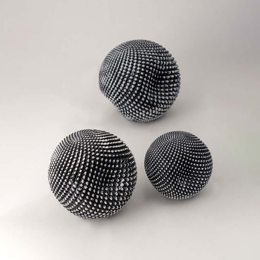 Set of black textured decorative spheres for elegant shelf styling and contemporary tabletop home decor displays.