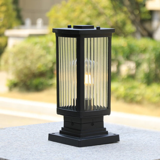 Modern black outdoor gate light with warm glow styled outdoors for elegant exterior decor ambiance.