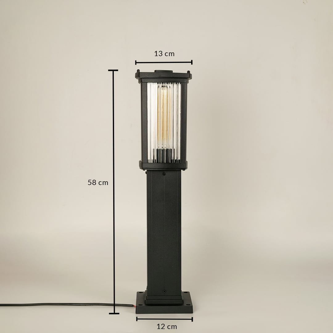 A black outdoor bollard light on a white background with dimensions clearly marked showing a height of 58 cm a top width of 13 cm and a base width of 12 cm illustrating its proportional structure.