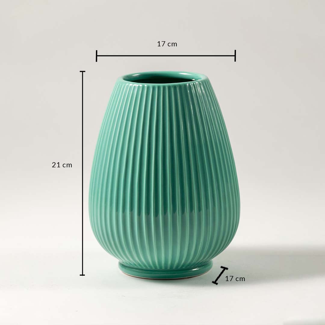 Green ceramic vase with ribbed design dimensions 21cm height and 17cm width for flowers and table decor.