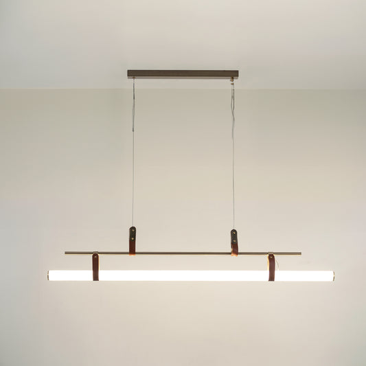 Black metal linear LED pendant light with integrated illumination creating sleek modern ambient ceiling lighting indoors.