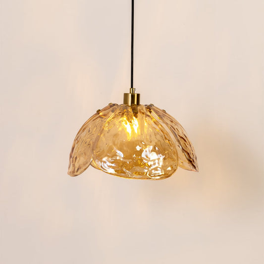 Amber textured glass and gold metal pendant light with warm illumination for stylish home decor interiors.