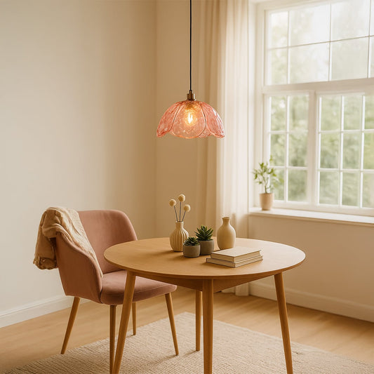 Pink textured glass and gold metal pendant light above dining table adding warmth to modern interiors.