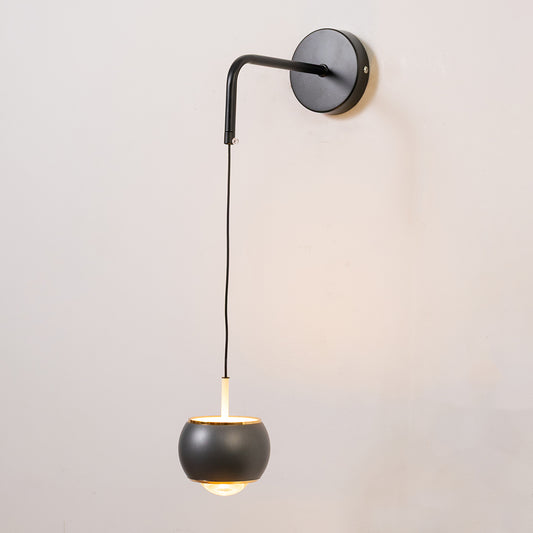 Contemporary wall light in black metal finish with hanging globe shade for bedroom or living decor lighting white background.
