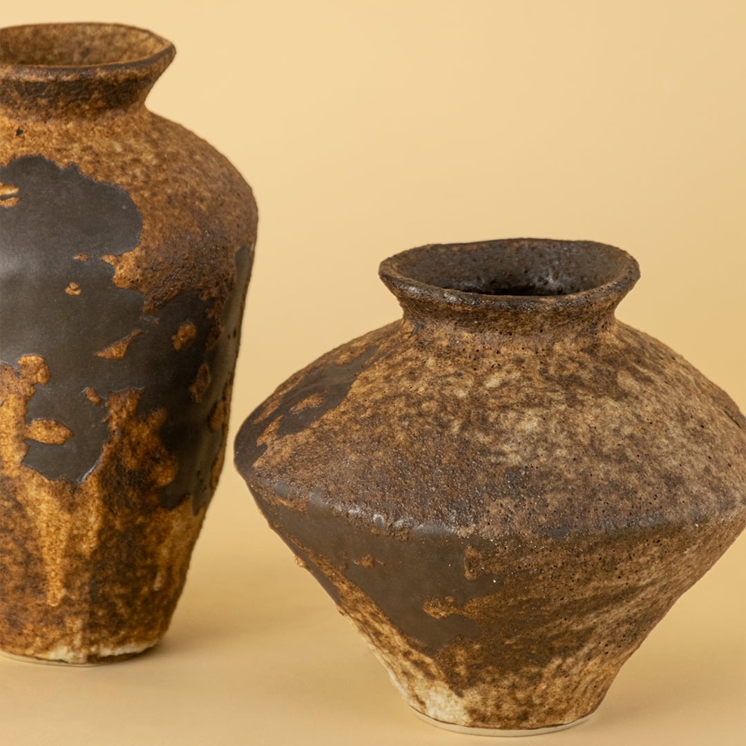 Detailed view of rustic brown ceramic vase highlighting unique handmade texture and natural earthy surface tone.