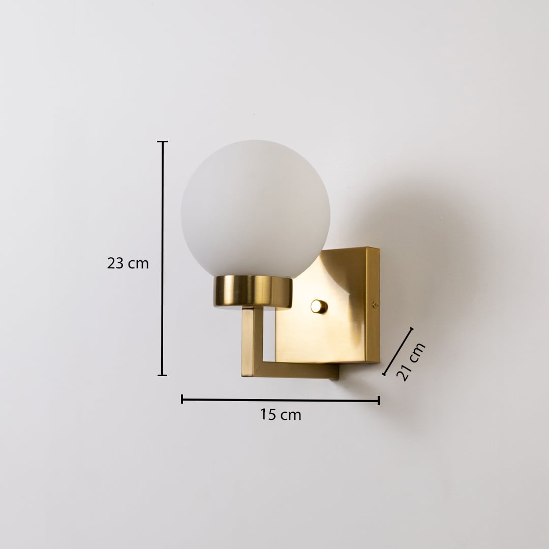 Gold metal wall light with frosted glass globe shade shown with 23 cm height 15 cm width and 21 cm depth for accurate indoor wall placement.