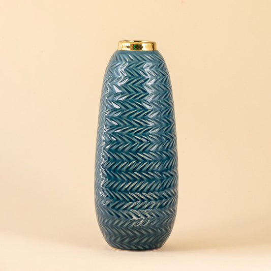 Blue ceramic decorative vase with embossed texture and gold rim for elegant shelf styling and modern home decor.