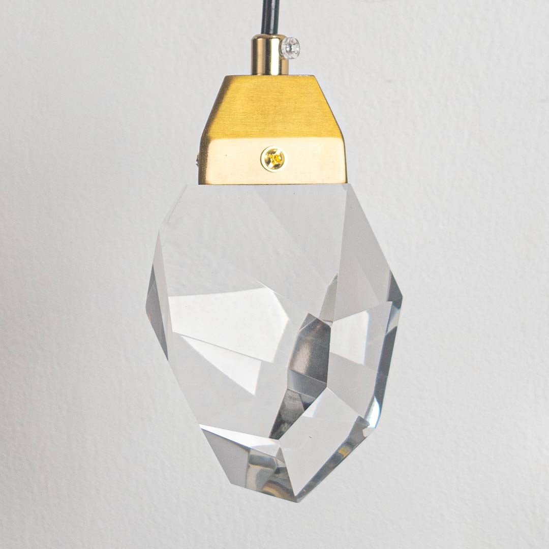 Closeup of luxury gold wall light with crystal shade showing elegant detailing for premium home and hotel lighting.
