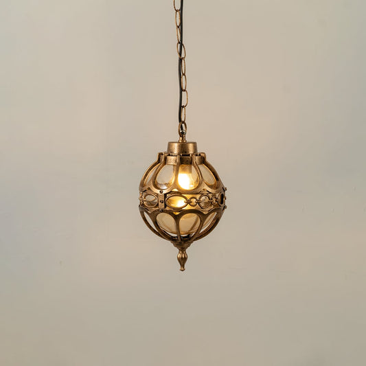 Illuminated black metal sphere pendant light with decorative cage design and warm bulb glowing against a plain white background.