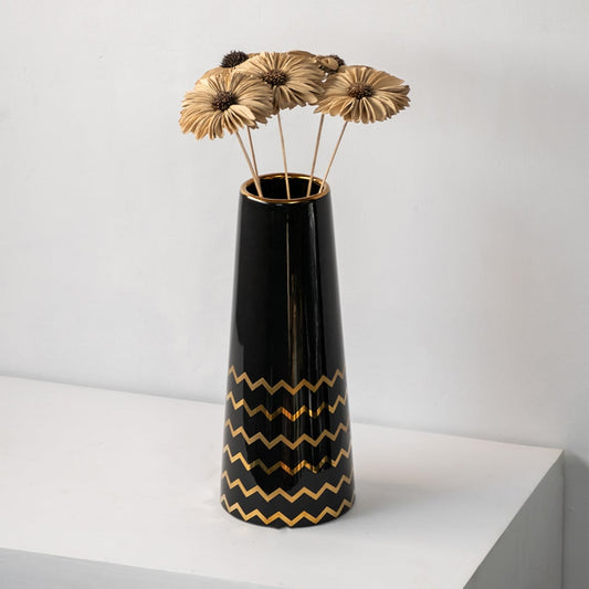 Black ceramic vase with gold zigzag design holding dried flowers modern table decor accent for living room.