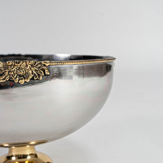 Main image of round silver bowl with golden base and decorative edge shown empty on clean background.
