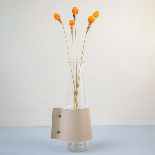 Bright orange dried flower stem styled in a warm modern room adding a bold natural accent to contemporary home decor.