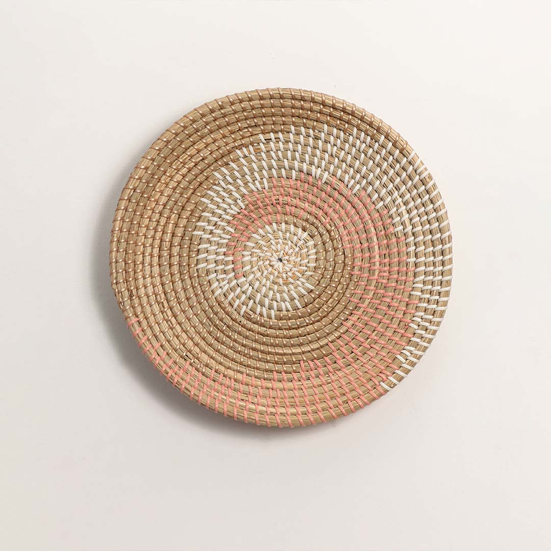 Natural and terracotta woven decorative wall basket with spiral pattern for elegant wall styling and modern home decor.