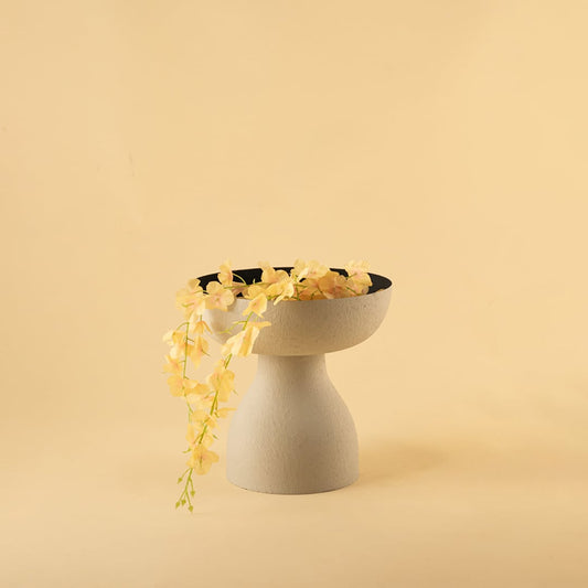 Grey textured pedestal vase bowl with black interior styled in a warm minimal scene adding modern elegance to home decor.
