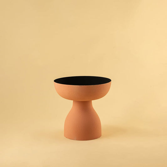 Terracotta orange pedestal bowl with matte finish and black interior displayed on a clean white background for modern decor styling.