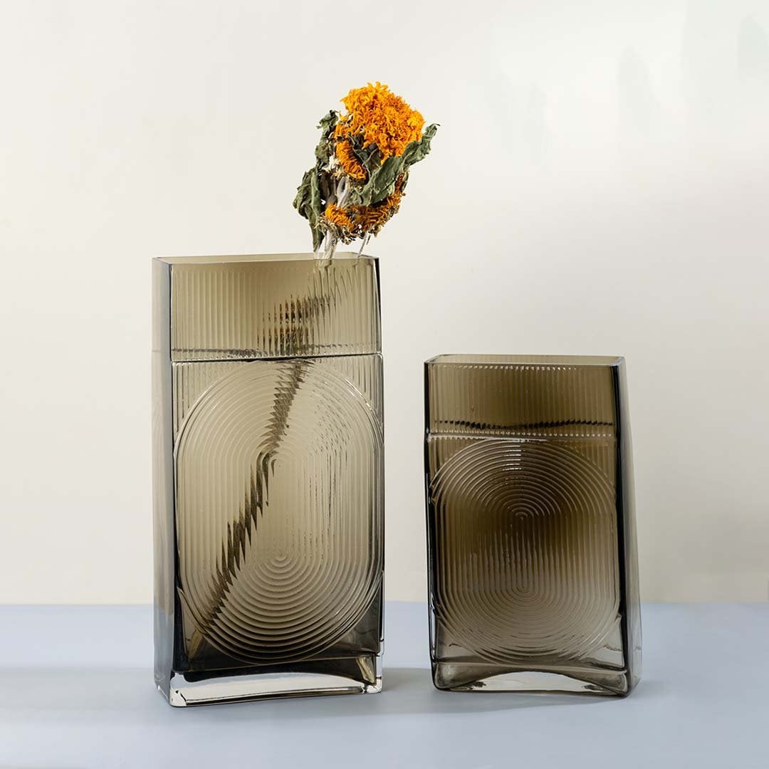 Set of ribbed glass vases in smoke brown rectangular tall modern decorative pieces light on white background for home styling accents.