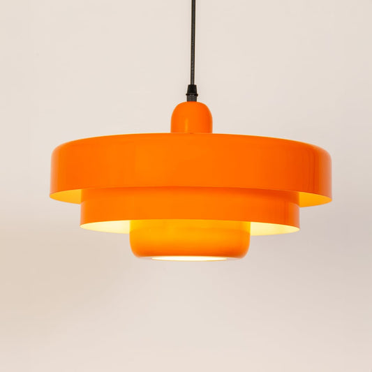 Orange metal pendant light with layered shade design for kitchen island dining room and modern ceiling lighting.