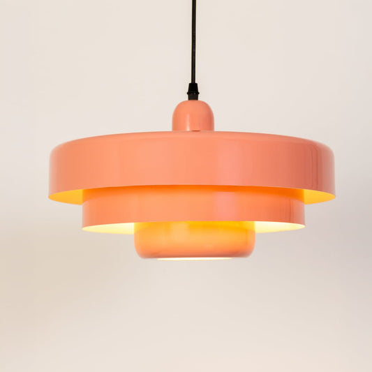 Modern peach metal pendant light glowing softly for kitchen and dining decor on a clean white background.