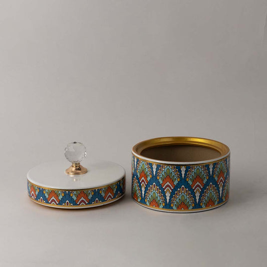 Decorative ceramic jar with artistic geometric pattern and gold accented crystal knob top for stylish home decor.