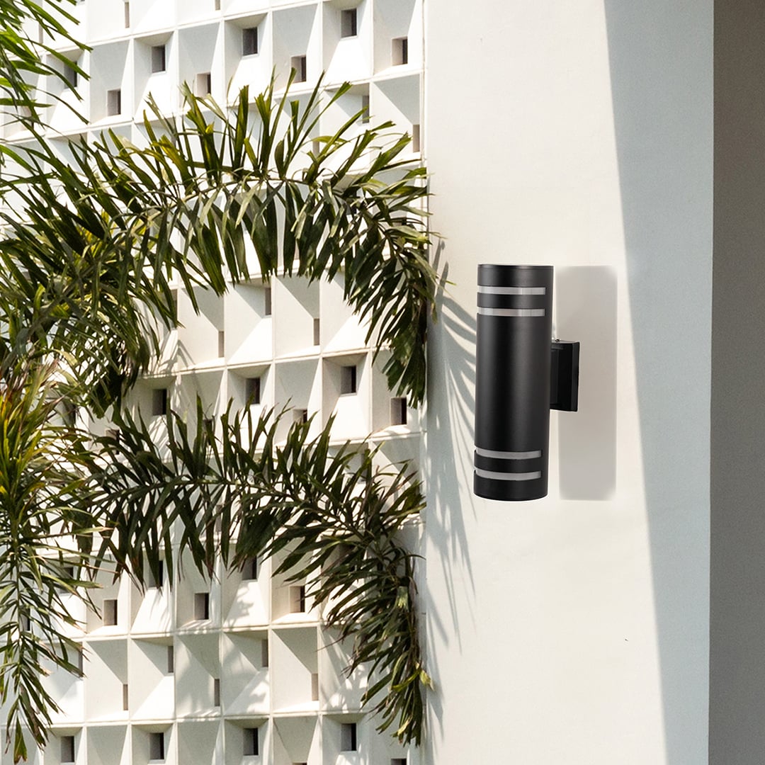 Modern outdoor black cylindrical wall light adding contemporary style and warm lighting to exterior walls.