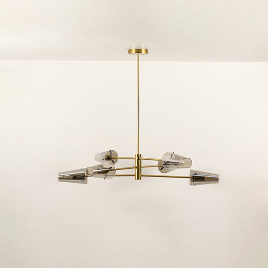 Clear glass shade chandelier with gold metal frame designed for elegant modern ceiling lighting in contemporary interiors.
