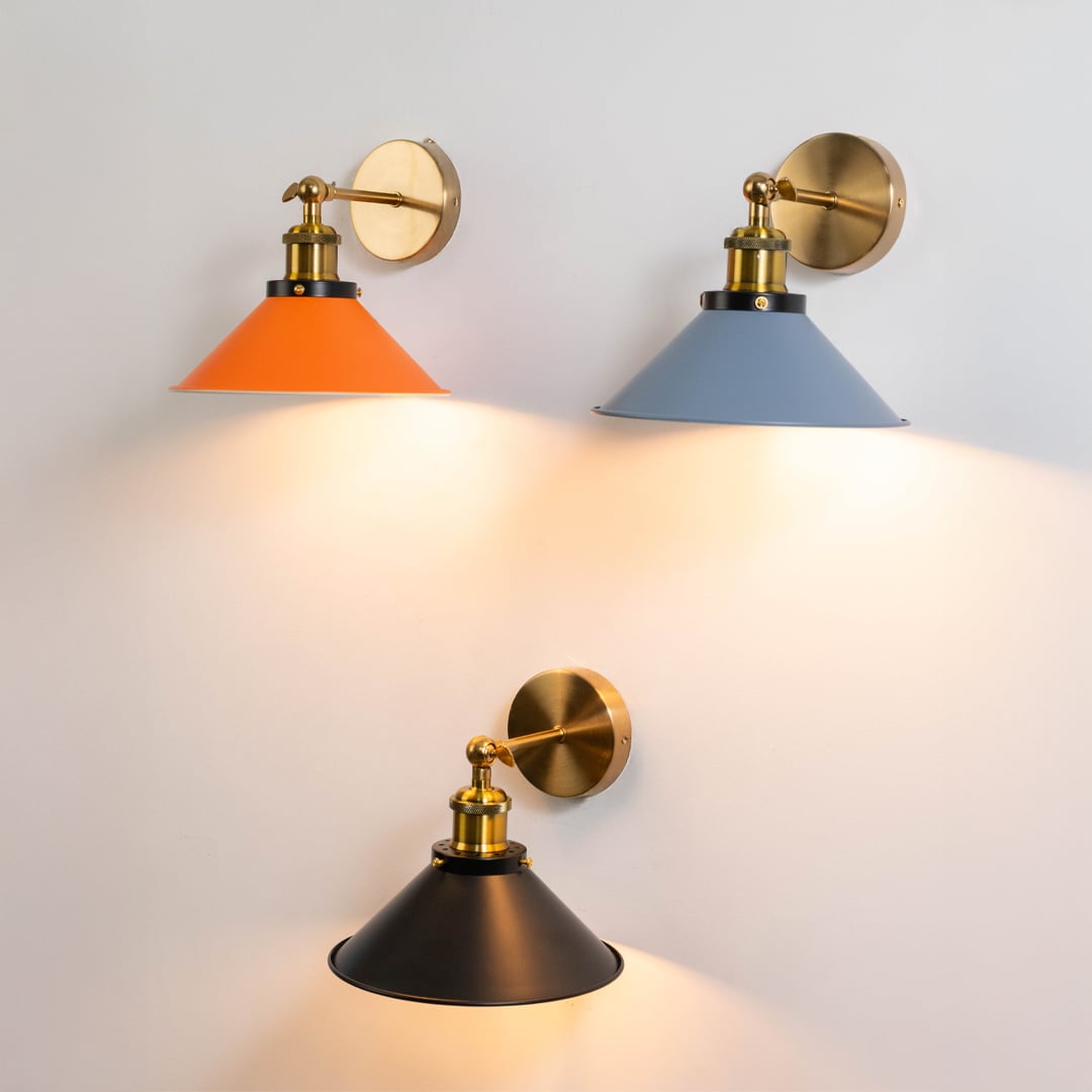 Set of orange brass wall lights displayed together enhancing modern interiors with bold color and contemporary design.