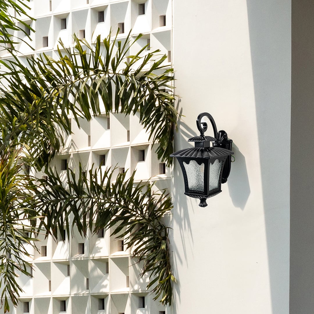 Outdoor lantern wall light illuminating a rustic brick wall adds vintage charm and warm brightness.
