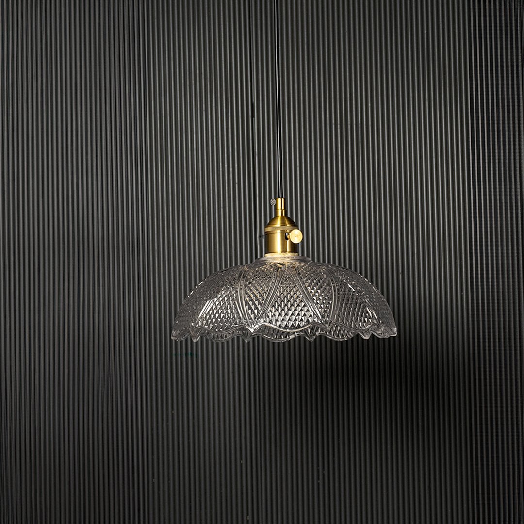 Crystal glass pendant light turned off against black background showing decorative vintage-style glass shade.