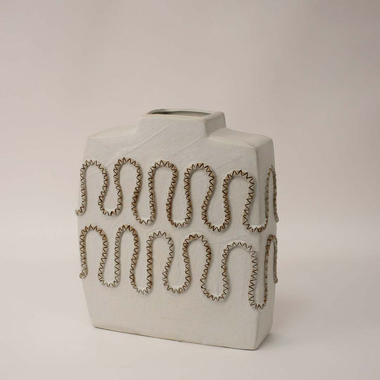 White ceramic decorative vase shown from side angle highlighting cutout pattern and sculptural profile for artistic home decor use.