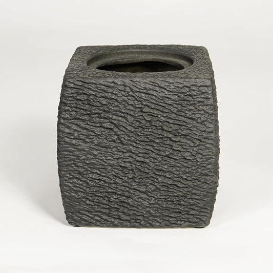 Dark grey decorative ceramic planter on white background modern home decor accent piece for table floor console styling.