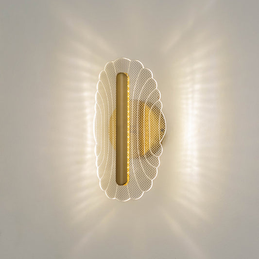 Decorative wall light in gold metal finish with textured glass diffuser for bedroom or living decor lighting placement white background.