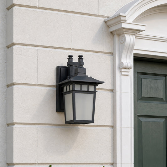 Modern black outdoor wall lantern lifestyle image with frosted glass shade mounted on an elegant white stone entryway.