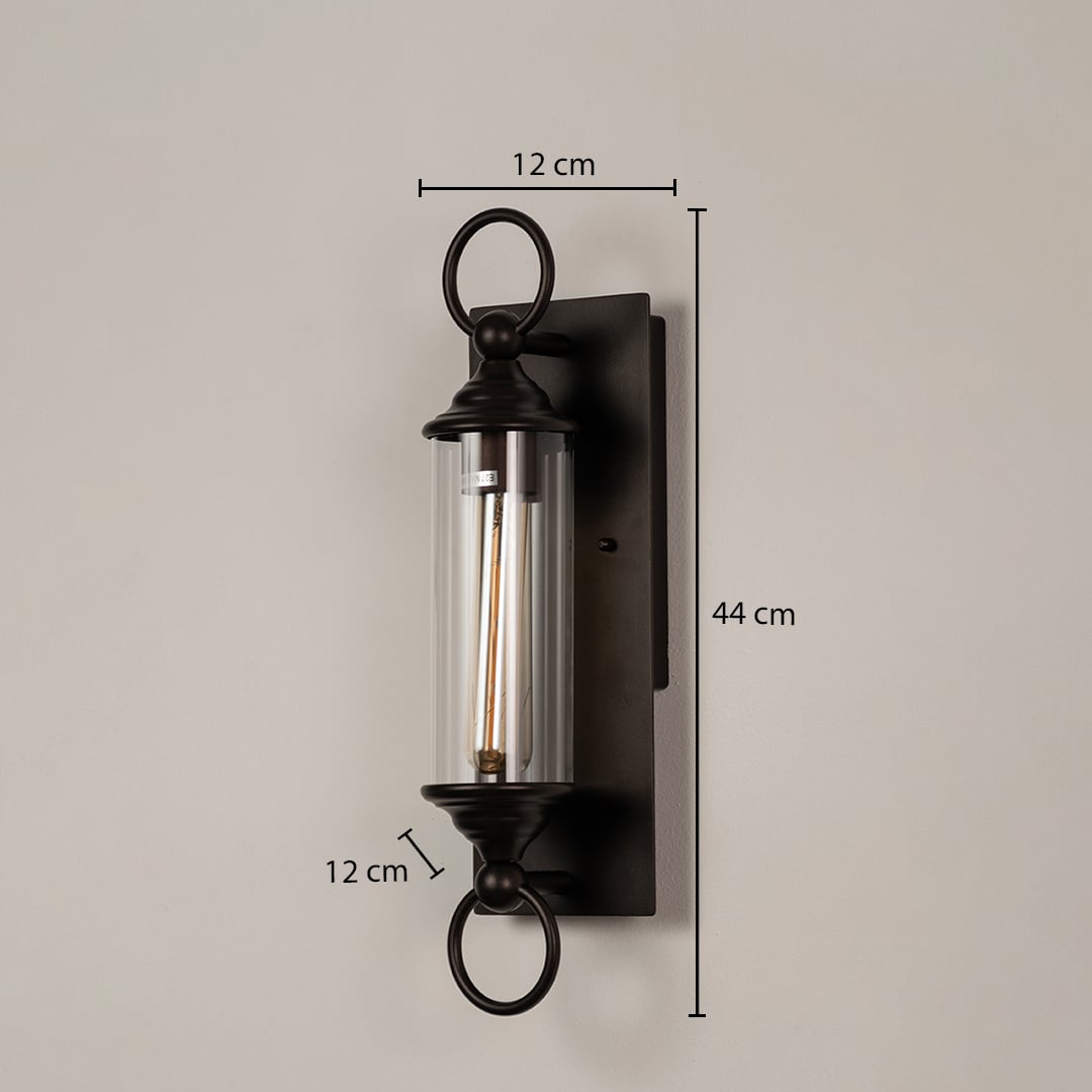 Black metal wall sconce with clear glass tube shown with dimensions 44 cm height 12 cm width and 12 cm depth for easy fitting.
