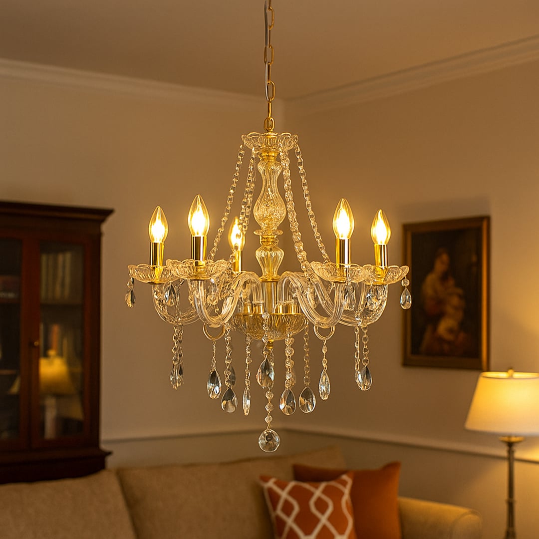 Gold chandelier glowing above a sofa with framed wall art and lamp creating a stylish and cozy living room.