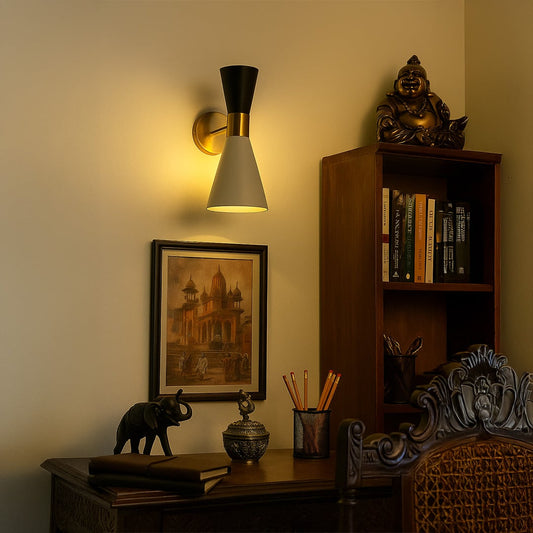 Modern black and white wall light with gold base illuminating a cozy room adding elegance to contemporary interiors.