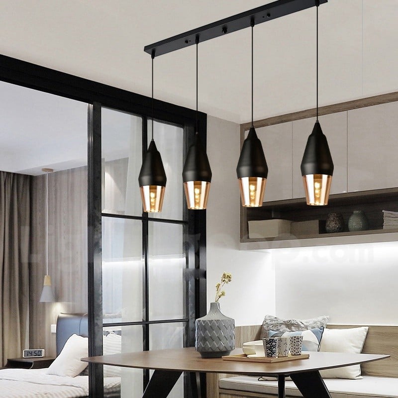 Black and amber glass pendant lights above kitchen island adding modern elegance and warm ambient lighting to interiors.