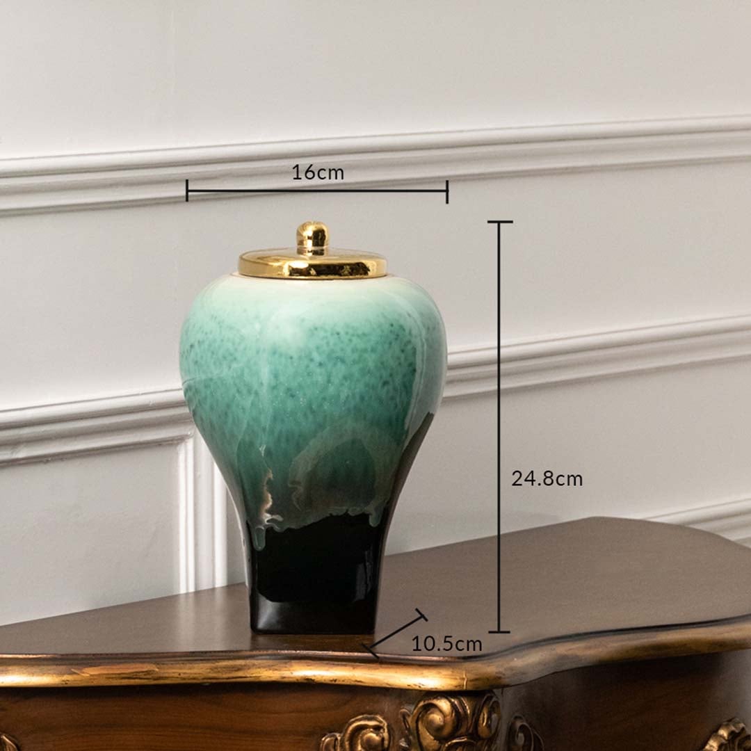 Green ceramic decor jar with black base and gold lid measuring 24.8 cm height 16 cm width and 10.5 cm base for tabletop decor.