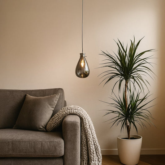 Designer chrome glass pendant light with smooth curved finish perfect for dining rooms bedrooms and modern living room interiors.