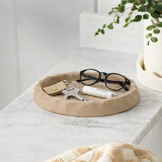 Brown wooden decorative tray placed on table with glasses and accessories modern minimal home decor styling idea.
