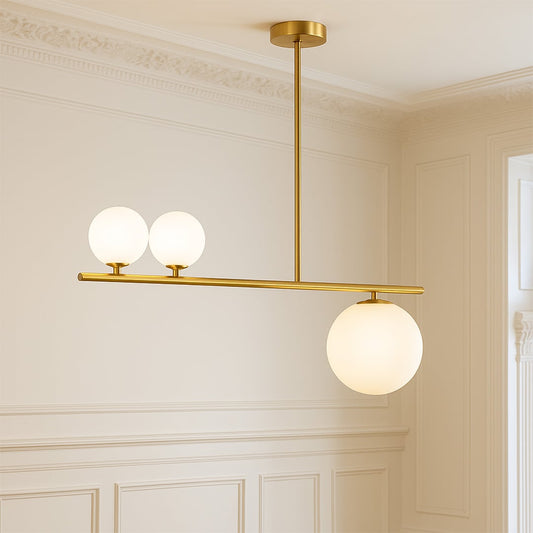 Modern gold chandelier with three frosted glass globes creating balanced illumination and luxurious ambiance perfect for dining or living spaces.