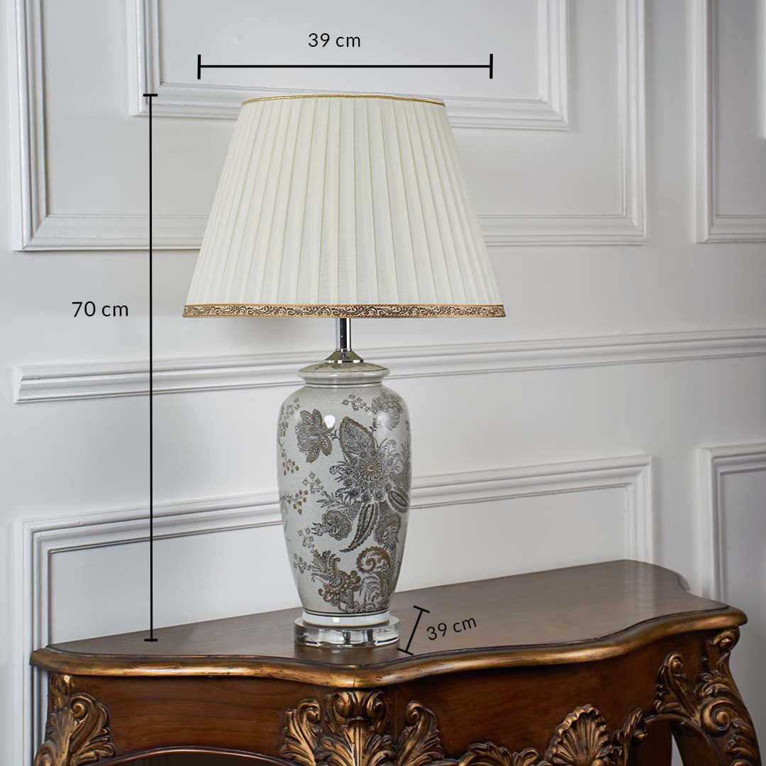 Ceramic table lamp with floral detailing shown with dimensions of 70 cm height and 39 cm shade width providing accurate sizing for placement.