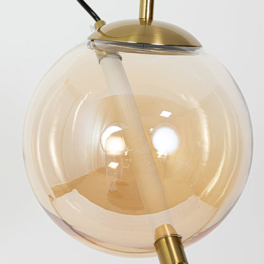 A closeup of a glass globe pendant light showing the warm glowing tubular LED inside and the smooth curved finish highlighting the refined modern craftsmanship.