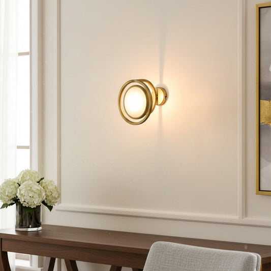 Modern gold ring wall light with warm glow for elegant living room and luxury decor styling spaces.