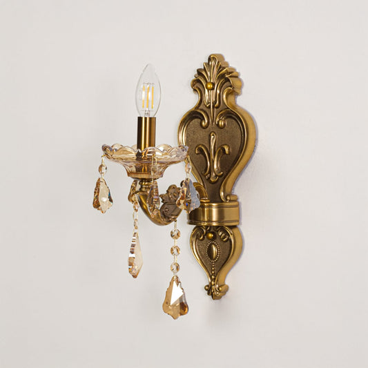 Wall light with gold metal frame and amber crystal accents displayed on a white background for clear refined product viewing.