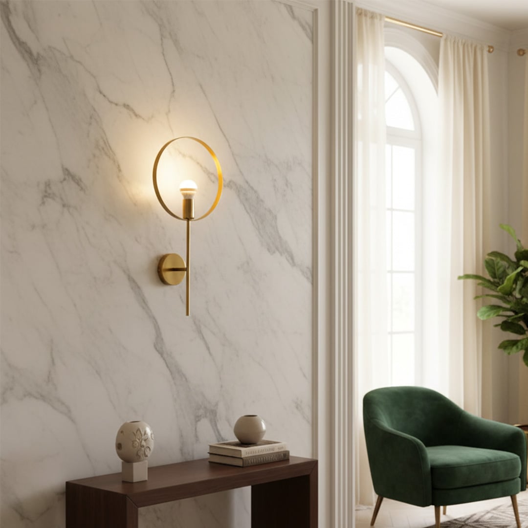 Wall mounted ring light in gold metal finish placed above console table creating soft ambient glow and modern accent for living room decor.