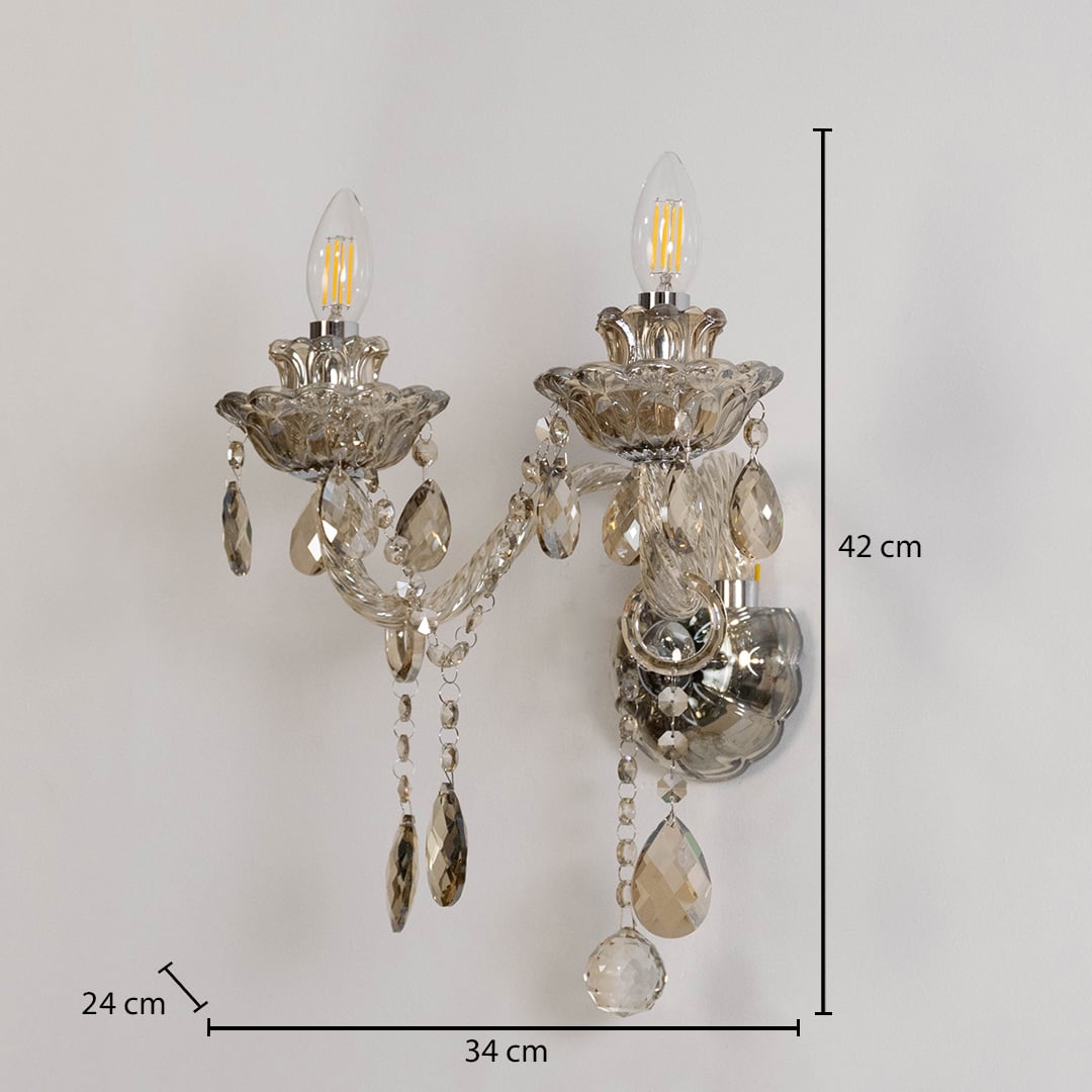 Crystal wall light with glass shade and hanging crystals size 25cm height 26cm width 12cm depth displayed with measurements.