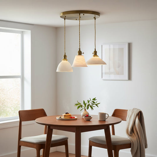 White metal pendant lights adding warm elegance above the dining table in modern interiors.